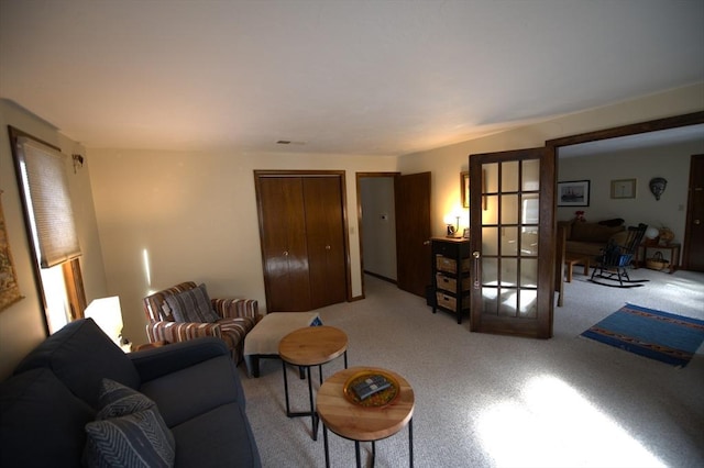 living room with visible vents and carpet flooring