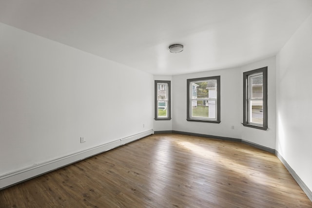 spare room featuring light wood-type flooring and baseboard heating