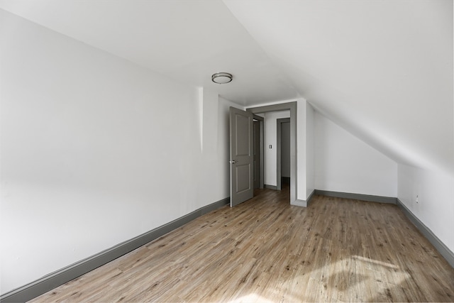 bonus room featuring hardwood / wood-style floors and vaulted ceiling