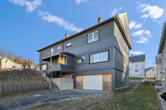 back of property featuring a garage