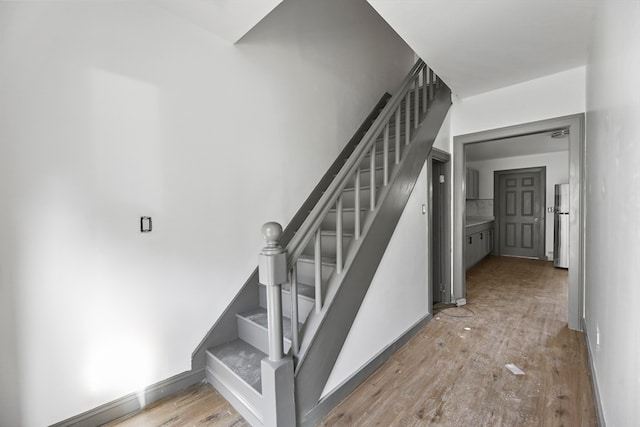 stairs featuring hardwood / wood-style floors