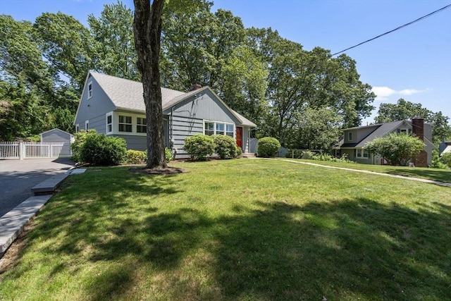 10 Morse Rd, Wayland, MA 01778 - view of front of house with an outbuilding, a chimney, and board and batten siding