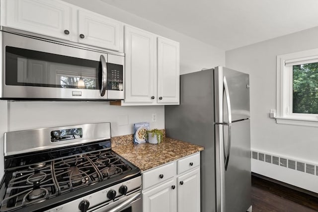 10 Morse Rd, Wayland, MA 01778 - kitchen featuring stainless steel appliances, radiator, white cabinets, dark wood-style floors, and dark stone countertops