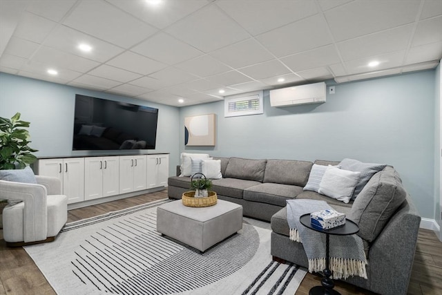 10 Morse Rd, Wayland, MA 01778 - living room featuring a wall unit AC, wood finished floors, recessed lighting, and a paneled ceiling