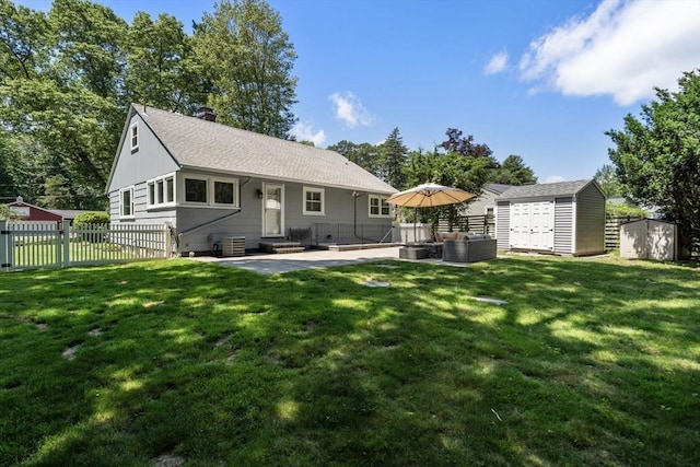 10 Morse Rd, Wayland, MA 01778 - back of house with a storage shed, a patio, a chimney, and a shingled roof