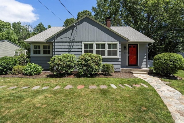 10 Morse Rd, Wayland, MA 01778 - view of front of property with a chimney, a front yard, and a shingled roof
