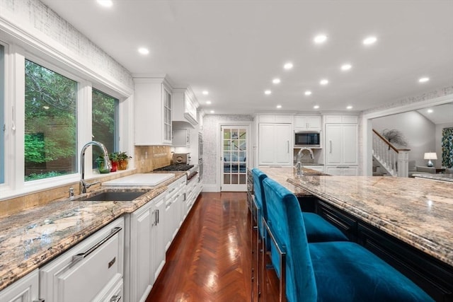 1 Croftdale, Newton, MA 02459 - kitchen featuring a sink, built in microwave, light stone countertops, white cabinetry, and recessed lighting