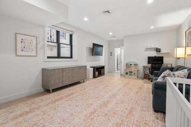 living room featuring baseboards, visible vents, and recessed lighting