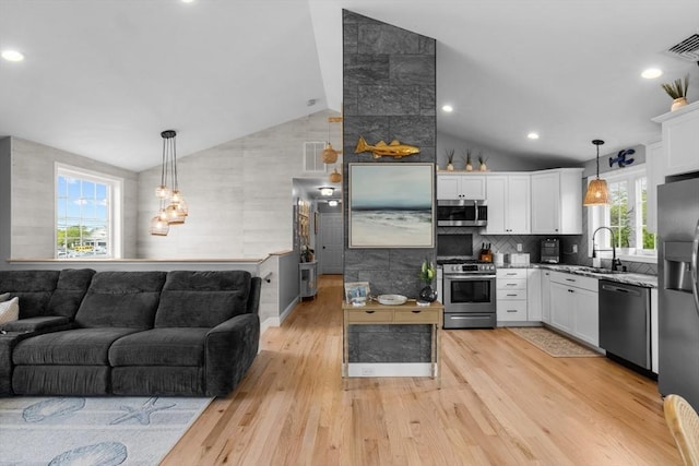 2 Jason Ter, Fairhaven, MA 02719 - kitchen featuring stainless steel appliances, a sink, white cabinetry, light wood finished floors, and light stone counters