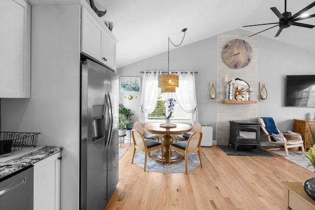 2 Jason Ter, Fairhaven, MA 02719 - dining space with vaulted ceiling, light wood-type flooring, ceiling fan, and a wood stove