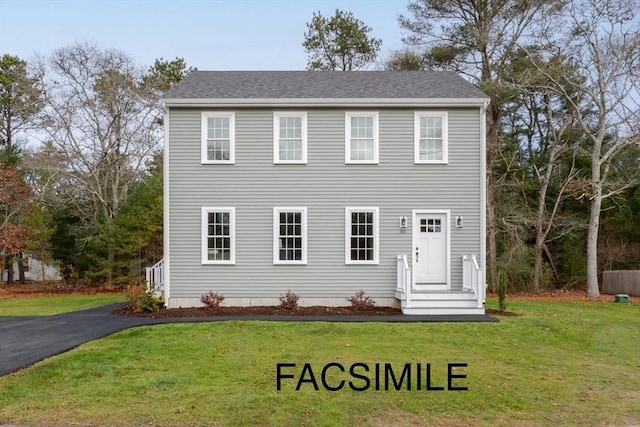 colonial inspired home with a front yard