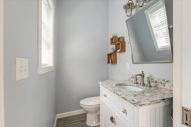33 Freeman Dr, Plymouth, MA 02360 - half bath with vanity, healthy amount of natural light, toilet, and baseboards