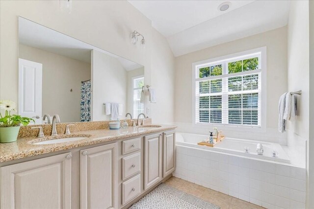 33 Freeman Dr, Plymouth, MA 02360 - full bath with double vanity, tile patterned floors, a bath, and lofted ceiling