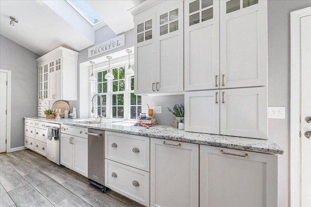33 Freeman Dr, Plymouth, MA 02360 - kitchen featuring white cabinetry, a sink, vaulted ceiling, light stone counters, and glass insert cabinets