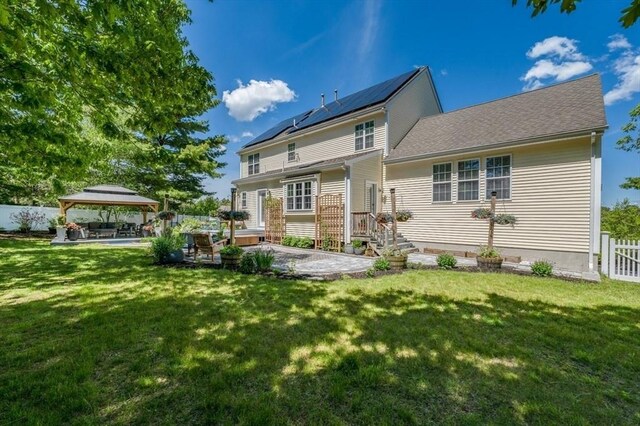 33 Freeman Dr, Plymouth, MA 02360 - rear view of property with a gazebo, a patio, and roof mounted solar panels