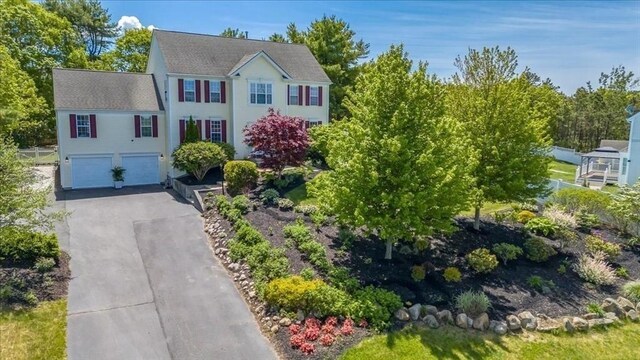 33 Freeman Dr, Plymouth, MA 02360 - colonial house with an attached garage, asphalt driveway, and roof with shingles