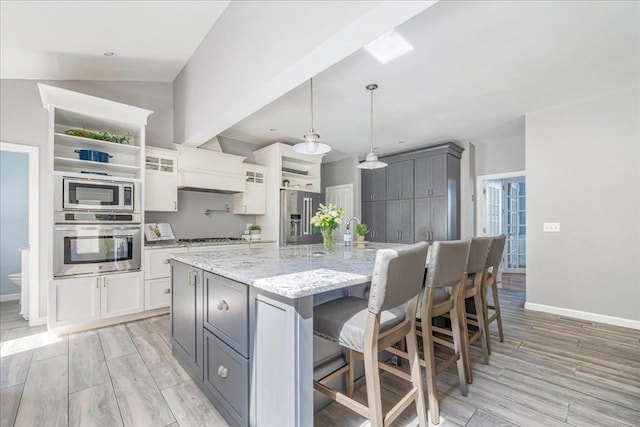 33 Freeman Dr, Plymouth, MA 02360 - kitchen featuring stainless steel appliances, baseboards, light wood finished floors, and light stone counters