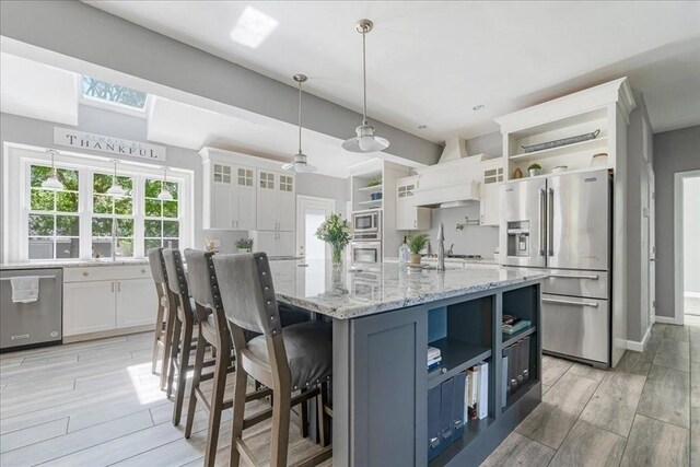 33 Freeman Dr, Plymouth, MA 02360 - kitchen with open shelves, stainless steel appliances, white cabinets, and light wood-style flooring