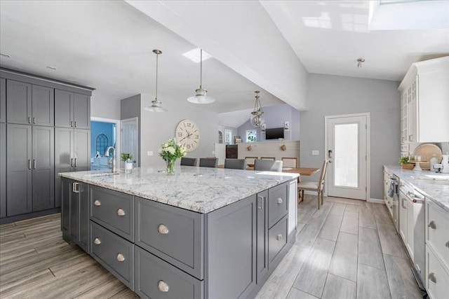 33 Freeman Dr, Plymouth, MA 02360 - kitchen with gray cabinetry, a sink, dishwasher, lofted ceiling, and a kitchen island with sink