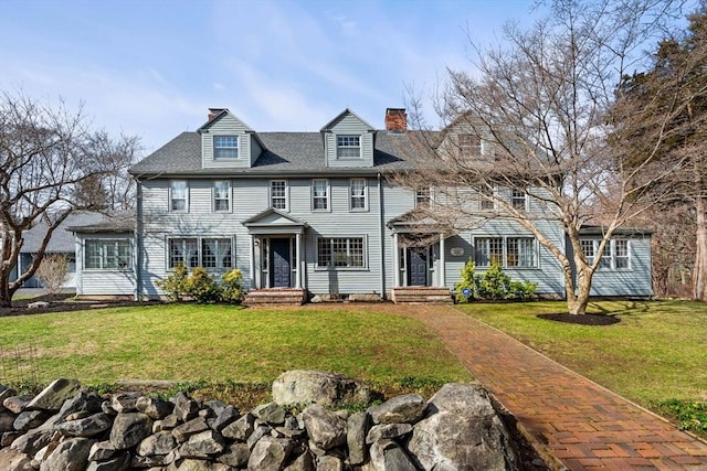 view of front of property with a chimney and a front yard