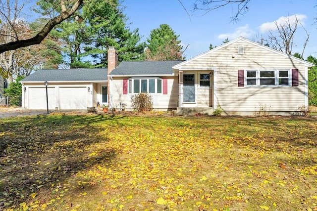 ranch-style home with a garage and a front yard