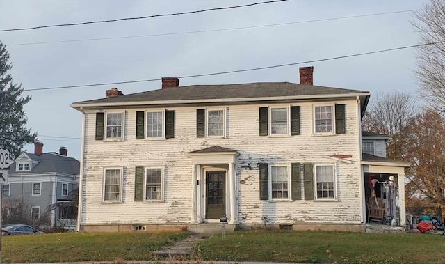 colonial home with a front yard