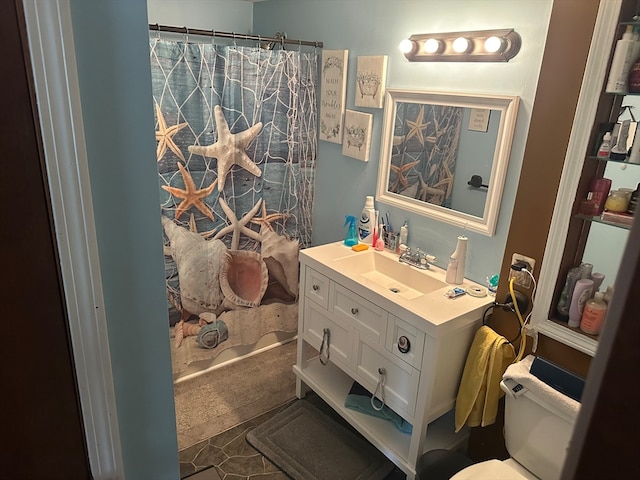 bathroom with tile patterned flooring, vanity, a shower with shower curtain, and toilet