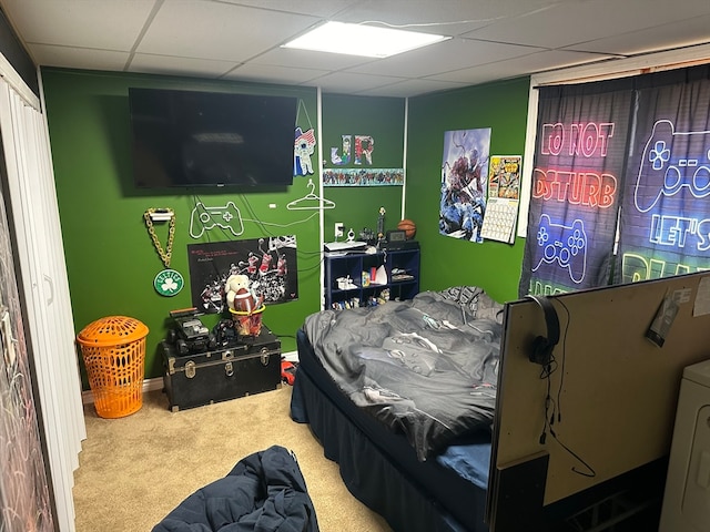 bedroom featuring carpet floors, washer / clothes dryer, and a drop ceiling