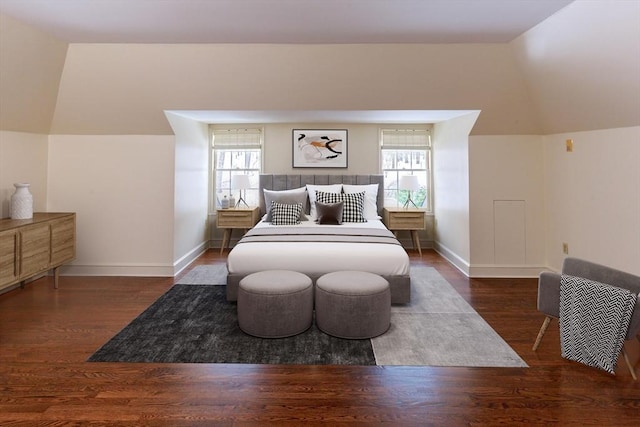 bedroom featuring baseboards, multiple windows, wood finished floors, and vaulted ceiling