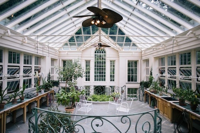 sunroom / solarium with lofted ceiling and ceiling fan