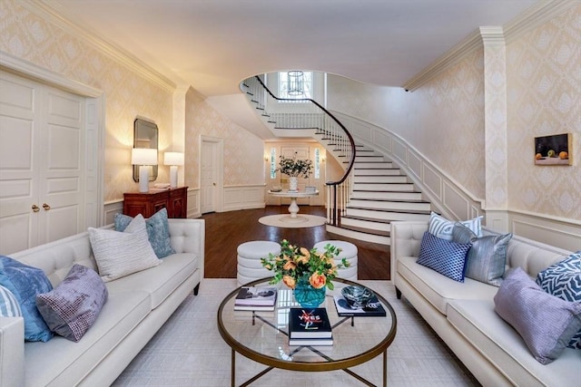 living area featuring wainscoting, wallpapered walls, stairs, and wood finished floors