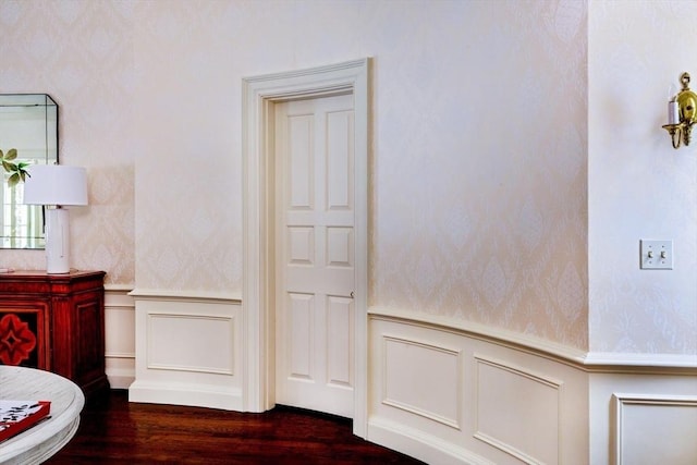 interior space with vanity, wood finished floors, wainscoting, and a decorative wall