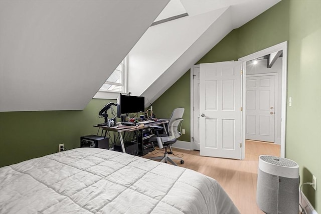 256 Lafayette St Unit 3, Salem, MA 01970 - bedroom with wood finished floors, vaulted ceiling, and an office area