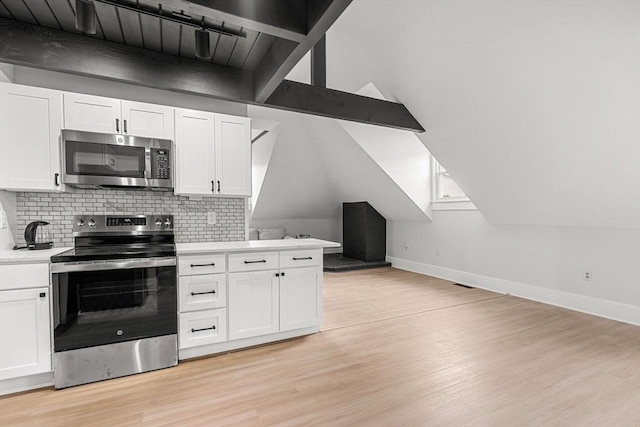 256 Lafayette St Unit 3, Salem, MA 01970 - kitchen featuring stainless steel appliances, light wood-style floors, white cabinetry, and tasteful backsplash