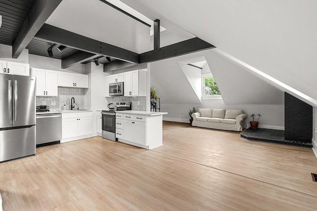 256 Lafayette St Unit 3, Salem, MA 01970 - kitchen with stainless steel appliances, light wood-style floors, tasteful backsplash, open floor plan, and white cabinetry