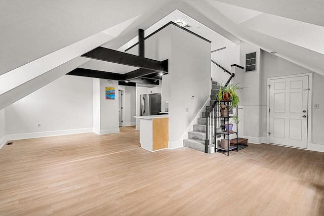 256 Lafayette St Unit 3, Salem, MA 01970 - living area featuring lofted ceiling, light wood-style floors, and stairway