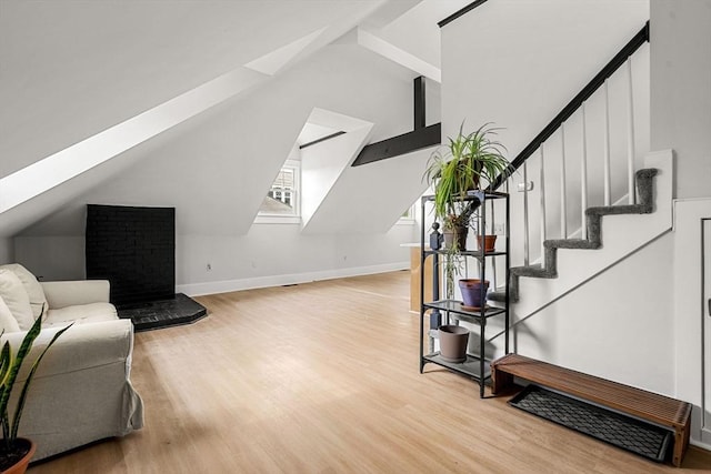 256 Lafayette St Unit 3, Salem, MA 01970 - living area with light wood-style flooring, vaulted ceiling, stairs, and a skylight