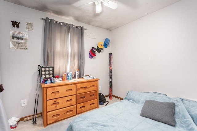 bedroom with baseboards, light colored carpet, and a ceiling fan
