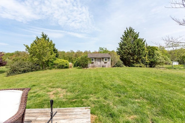 view of grassy yard featuring an outdoor structure and a storage shed