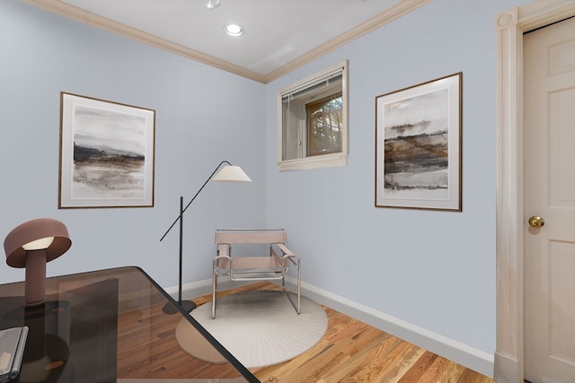 sitting room featuring wood-type flooring and crown molding