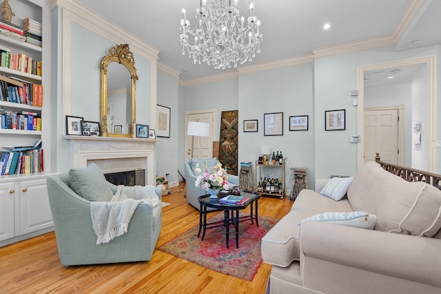 living room featuring light hardwood / wood-style flooring, a chandelier, and ornamental molding