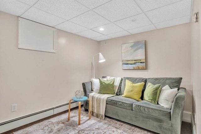 carpeted living room with a baseboard heating unit, a paneled ceiling, recessed lighting, and baseboards