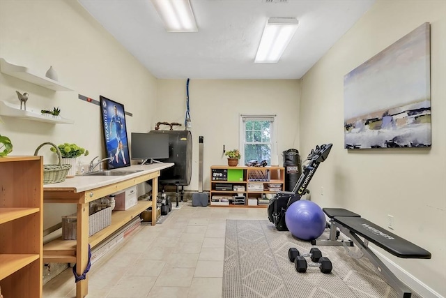 workout area with a sink and light tile patterned floors