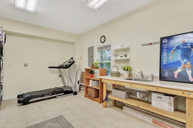 workout room featuring a sink, electric panel, and light tile patterned flooring