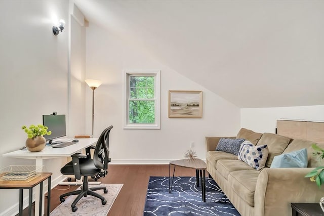 office with dark wood-style floors, vaulted ceiling, and baseboards