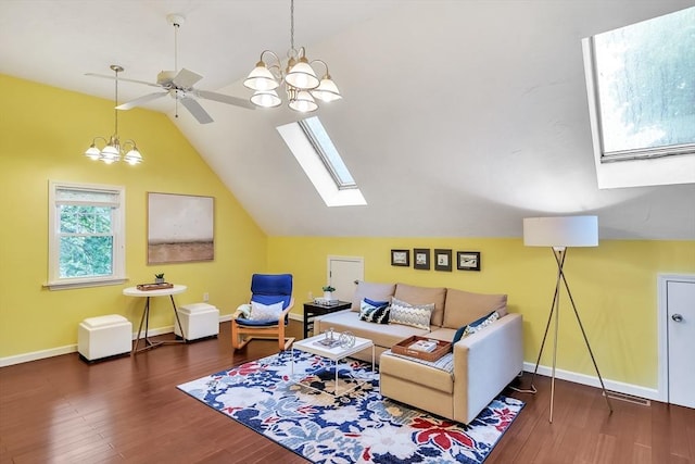 living area with vaulted ceiling, ceiling fan, wood finished floors, baseboards, and a chandelier