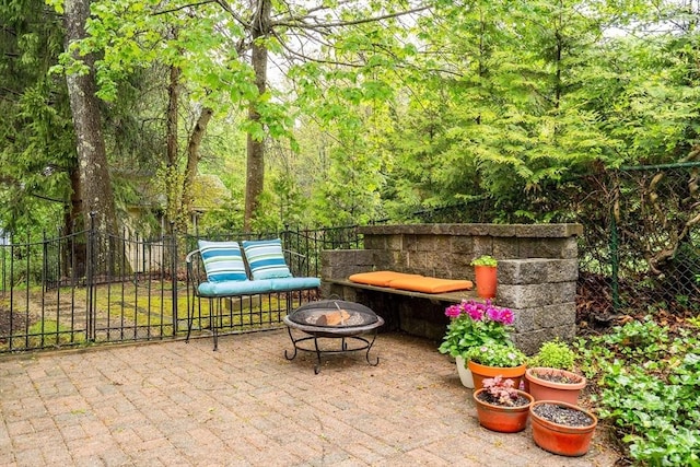 view of patio / terrace featuring a fire pit and fence