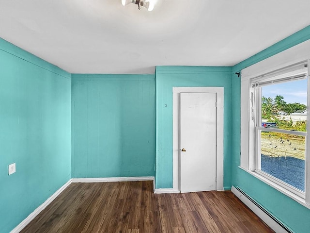 19 High St, Lynn, MA 01902 - unfurnished bedroom with a baseboard radiator and wood finished floors
