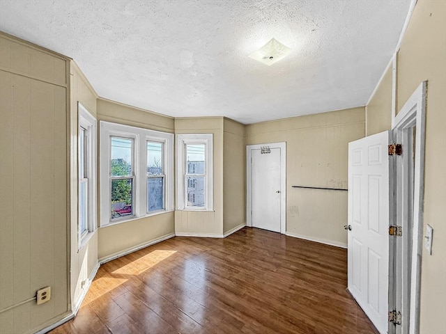 19 High St, Lynn, MA 01902 - unfurnished bedroom featuring wood finished floors and a textured ceiling