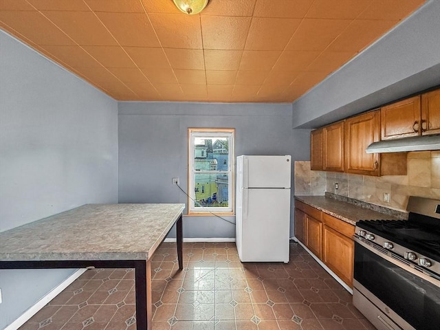 19 High St, Lynn, MA 01902 - kitchen with freestanding refrigerator, stainless steel range with gas cooktop, range hood, brown cabinetry, and backsplash